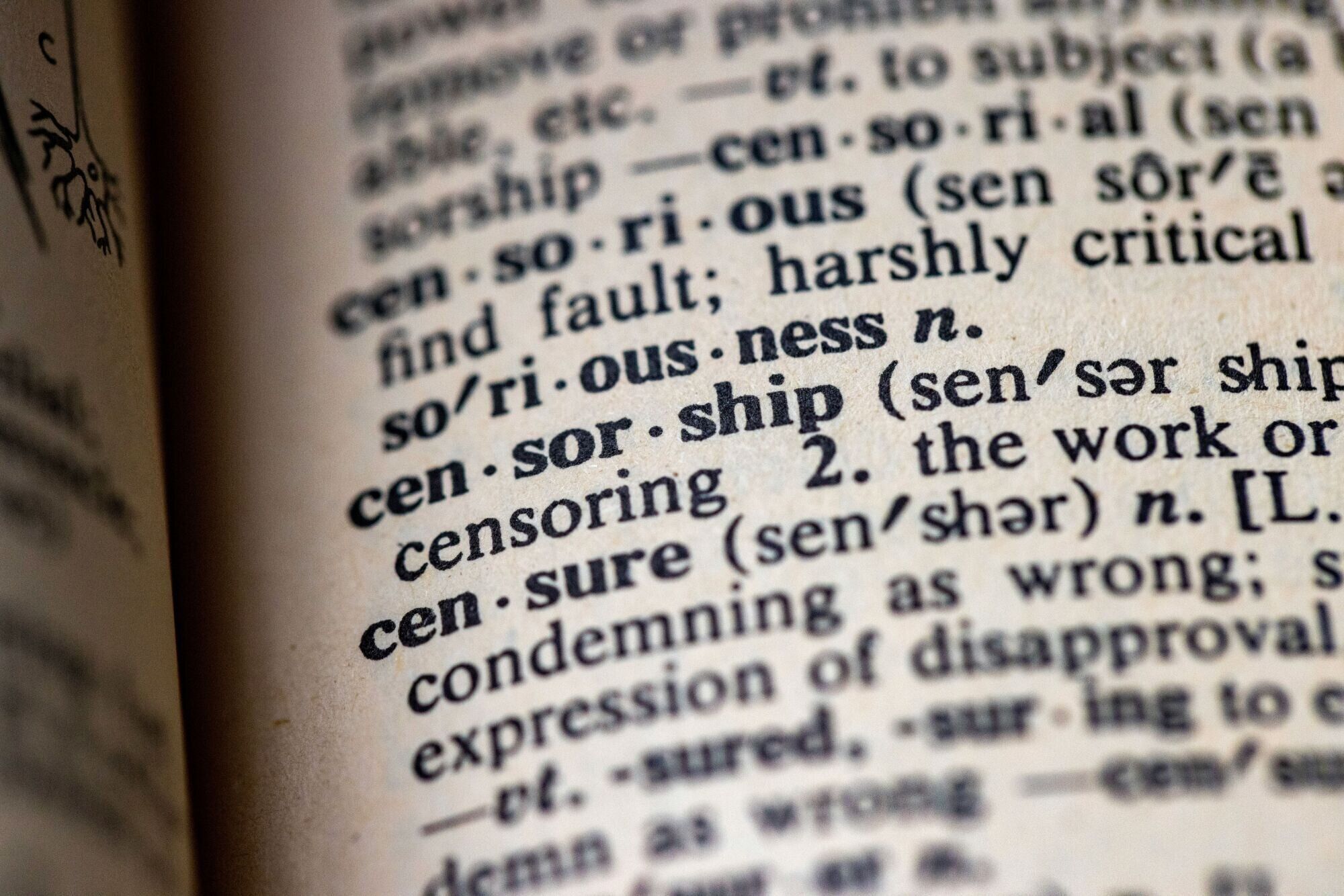 An image of the definition of censorship on the open page of a dictionary.