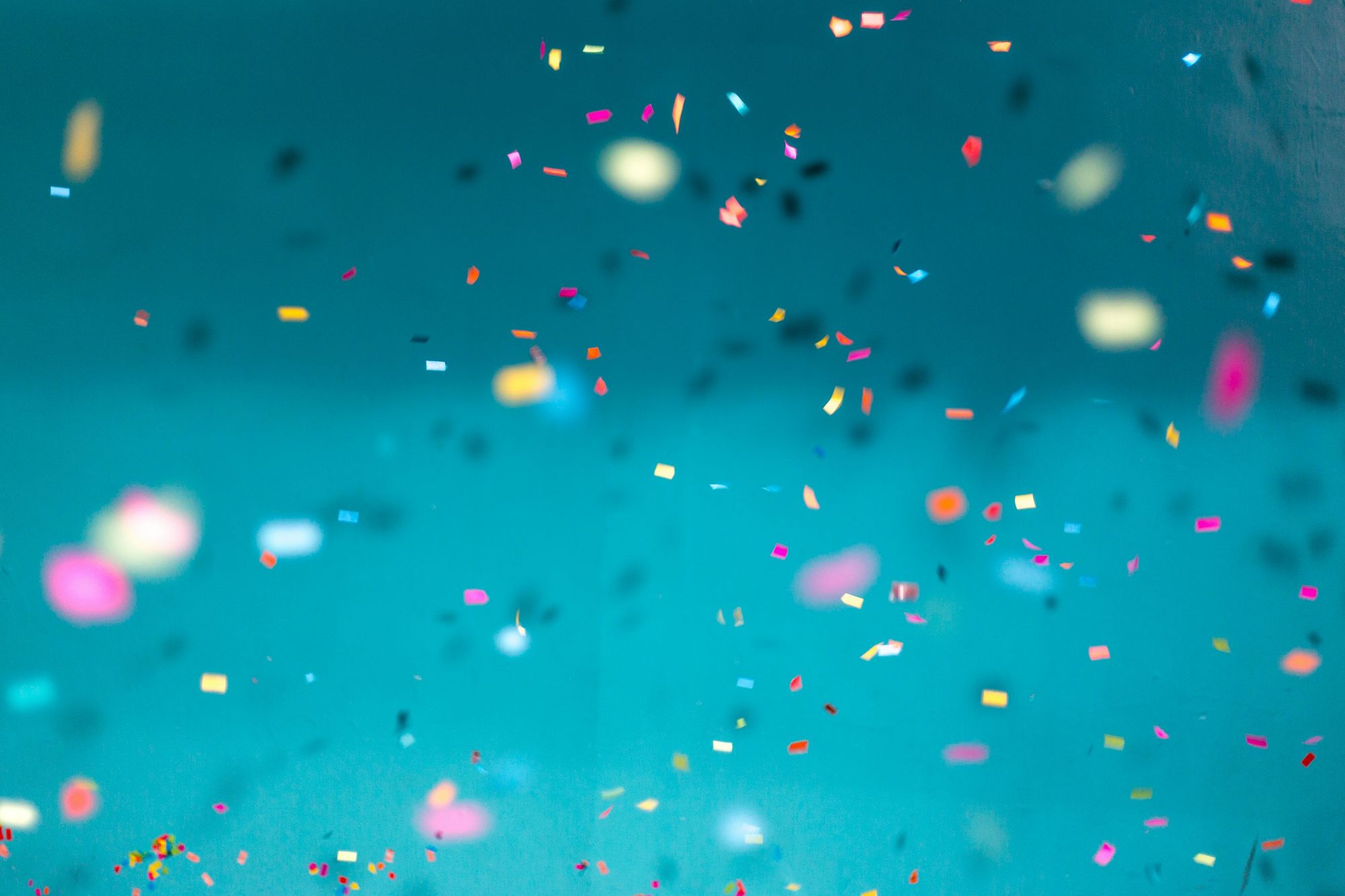 An image of confetti falling on a blue background