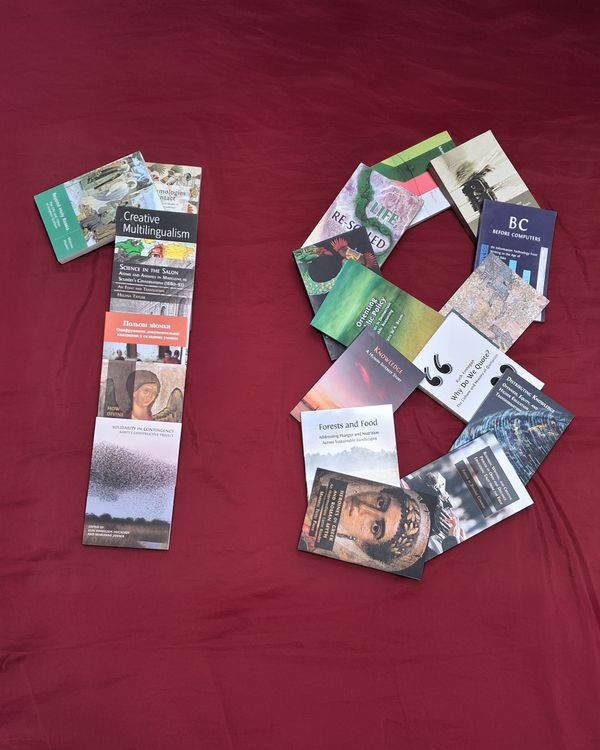 OBP books arranged on a red background into the shape of the number 18